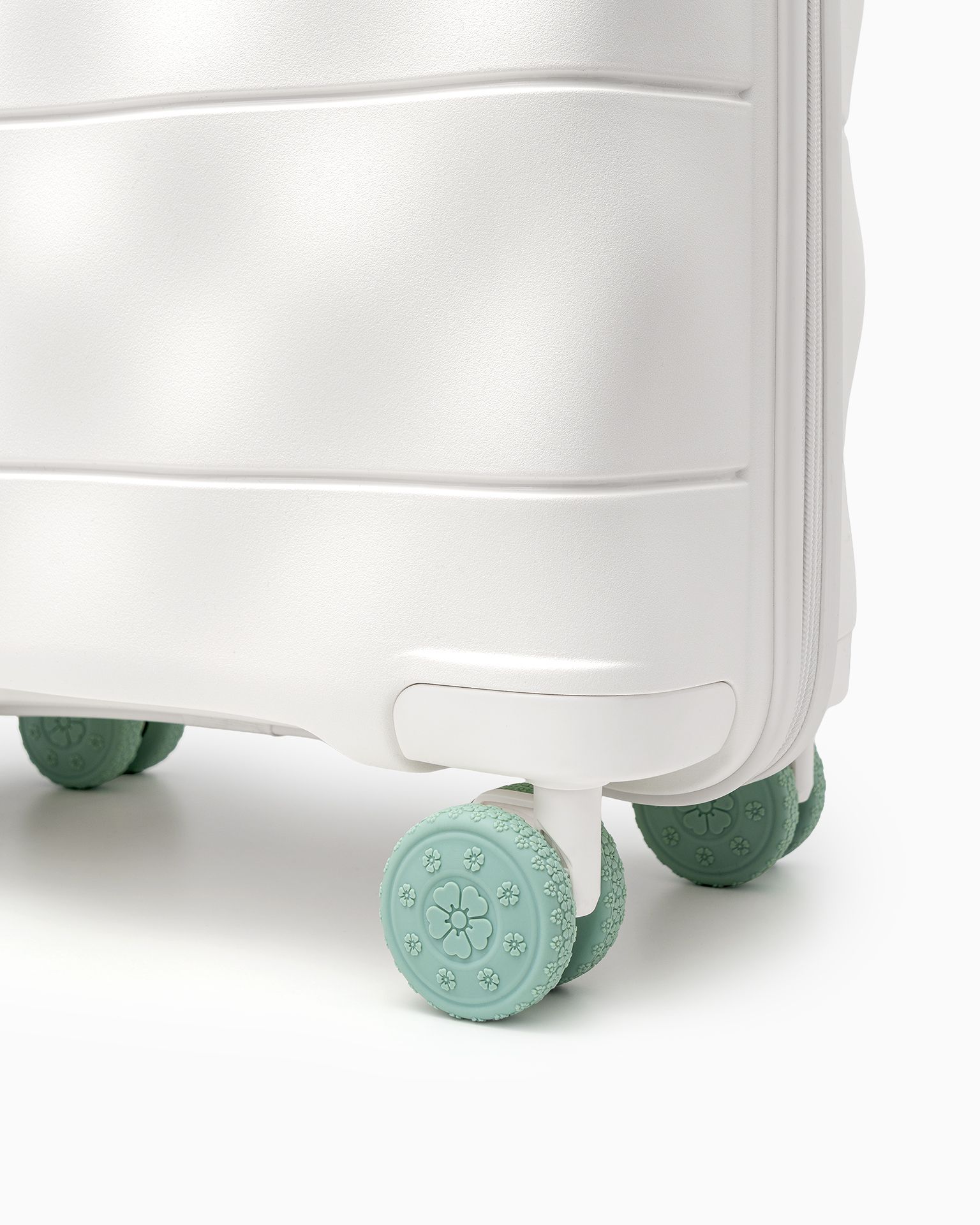 Zöld bőrönd kerekeihez való védőpárnák